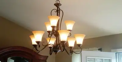 Classic ceiling chandelier installation with warm lighting in Dallas, TX