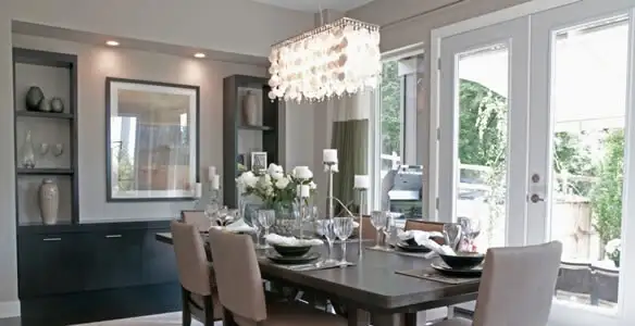 Elegant dining room chandelier installation above table in Dallas, TX