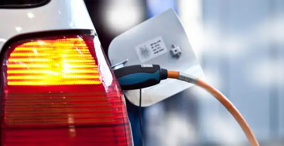 Electric car plugged into EV charger after professional installation in Dallas, TX