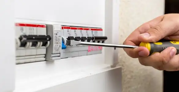 electrical panel upgrade service showing technician adjusting circuit breakers during system upgrade in Dallas, TX
