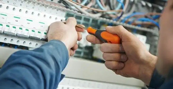 electrical service showing licensed electrician performing electrical panel maintenance and adjustments in Dallas, TX