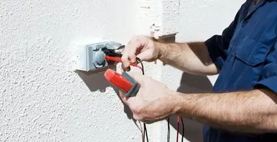 Electrician performing home electrical outlet and wiring inspection in Dallas, TX