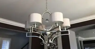 Modern chandelier installation with multiple light fixtures in Dallas, TX