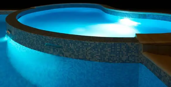 pool light installation and repair services highlighting illuminated pool interior lighting in Dallas, TX