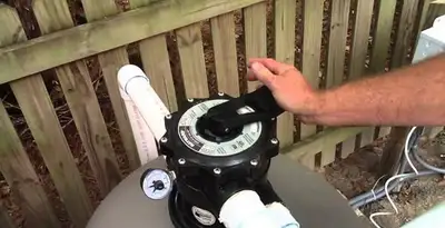 pool pumps service showing professional adjustment of pool pump control system in Dallas, TX