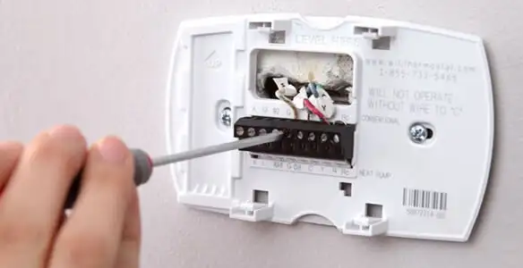 Thermostat installation service with proper wiring and secure wall mounting in Dallas, TX