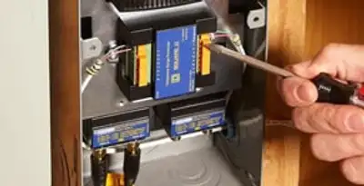 Whole home surge protection device being installed by a licensed electrician to protect electrical systems in Dallas, TX